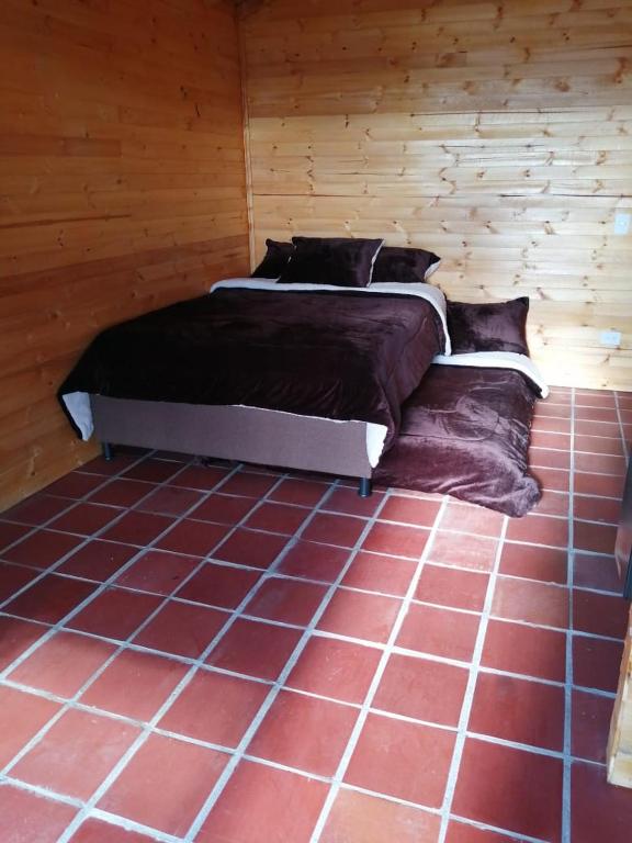Postel nebo postele na pokoji v ubytování Guatavita Campestre Suites
