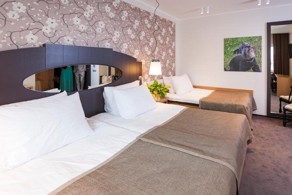 Postel nebo postele na pokoji v ubytování Paide SPA Hotell