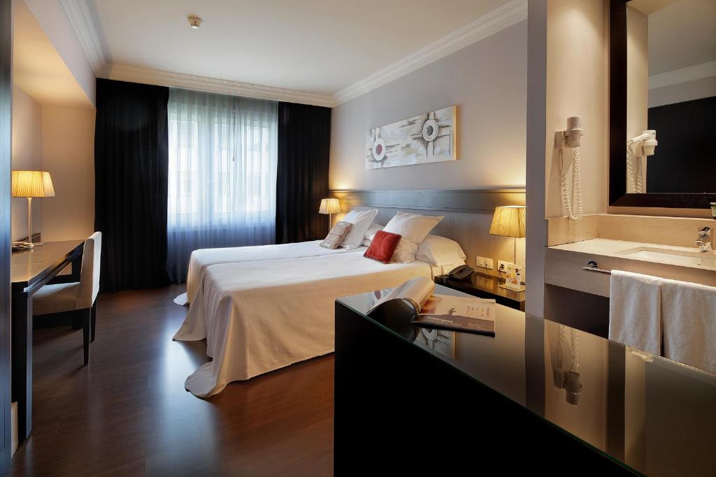 a hotel room with a bed and a sink at Hotel Condado in Barcelona