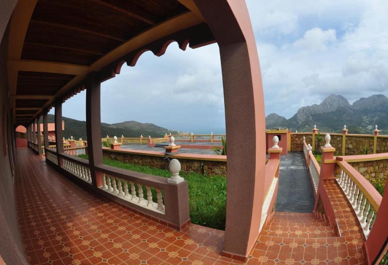 a walkway with a view of the water and mountains at Coopérative Village Jbel Moussa du Tourisme in Rcham