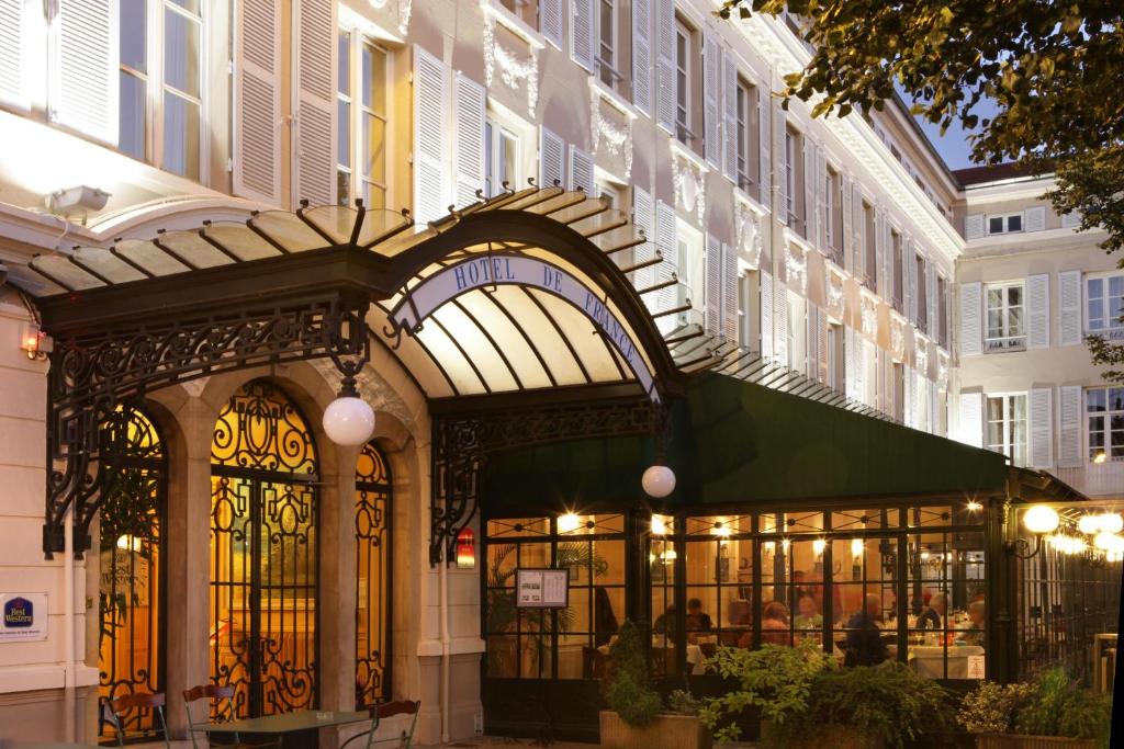 an entrance to a building with a green awning at Best Western Hôtel de France in Bourg-en-Bresse