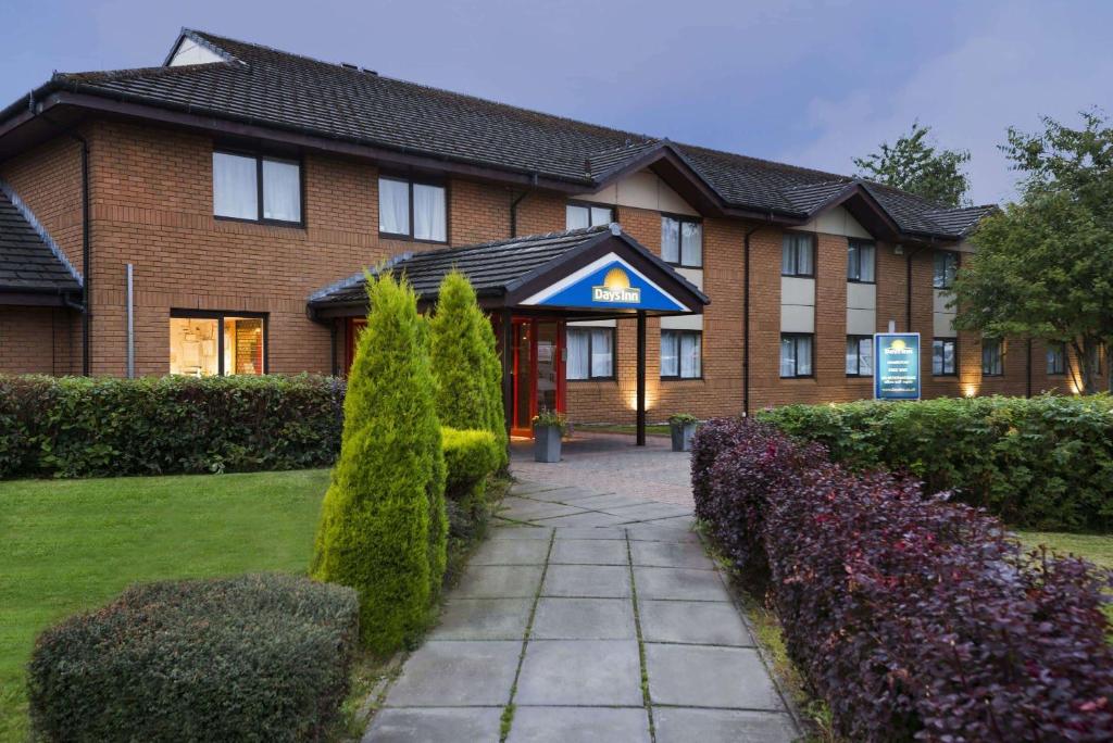 a brick building with a pathway in front of it at Days Inn Hamilton in Hamilton