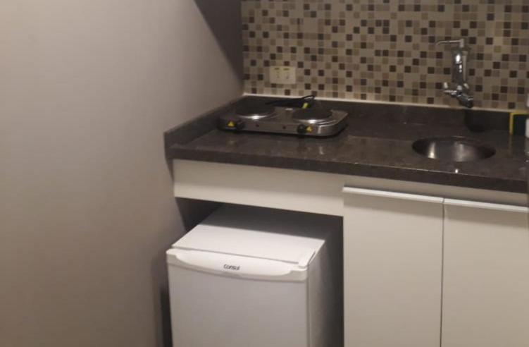 a small kitchen with a sink and a counter at apartamento otima localizacao itaim bibi in Sao Paulo