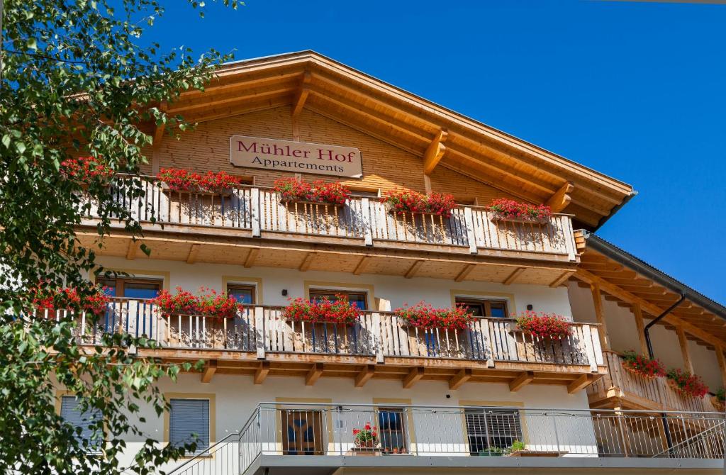 a building with flower boxes on the balconies at Mühlerhof in Funes
