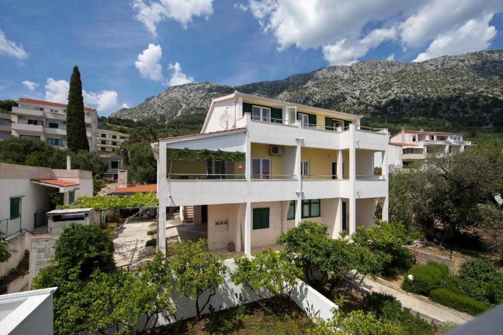 an aerial view of a building with mountains in the background at Apartments Ruzica - sea view in Igrane