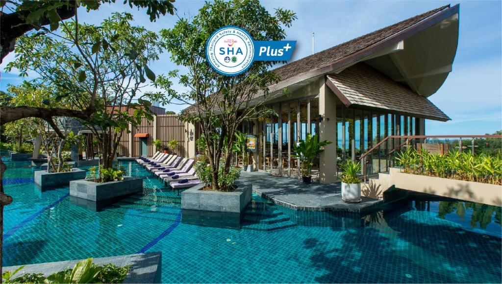 a resort with a swimming pool and a building at Mandarava Resort and Spa, Karon Beach - SHA Extra Plus in Karon Beach