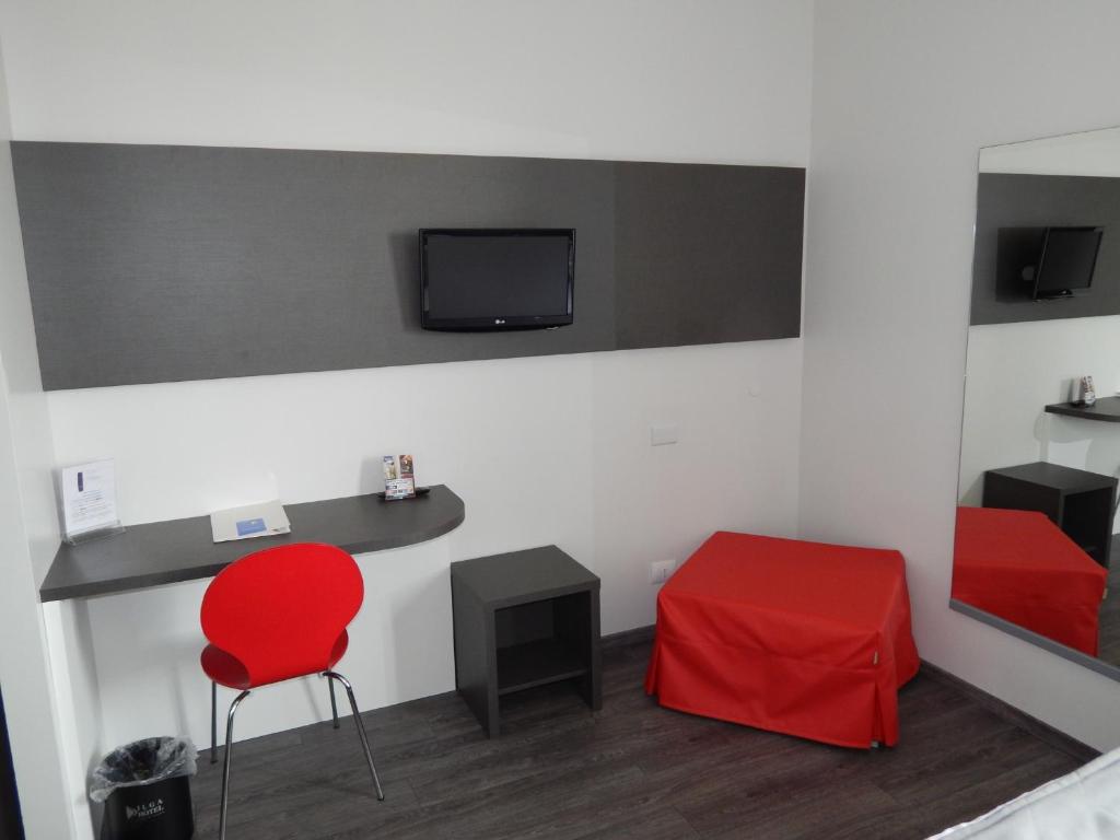Telewizja i/lub zestaw kina domowego w obiekcie Ilga Hotel