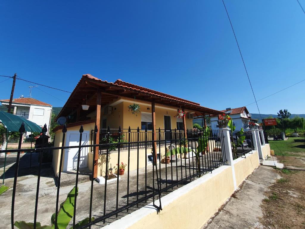 a black fence in front of a house at Villa Sunny Day Riviera in Asprovalta