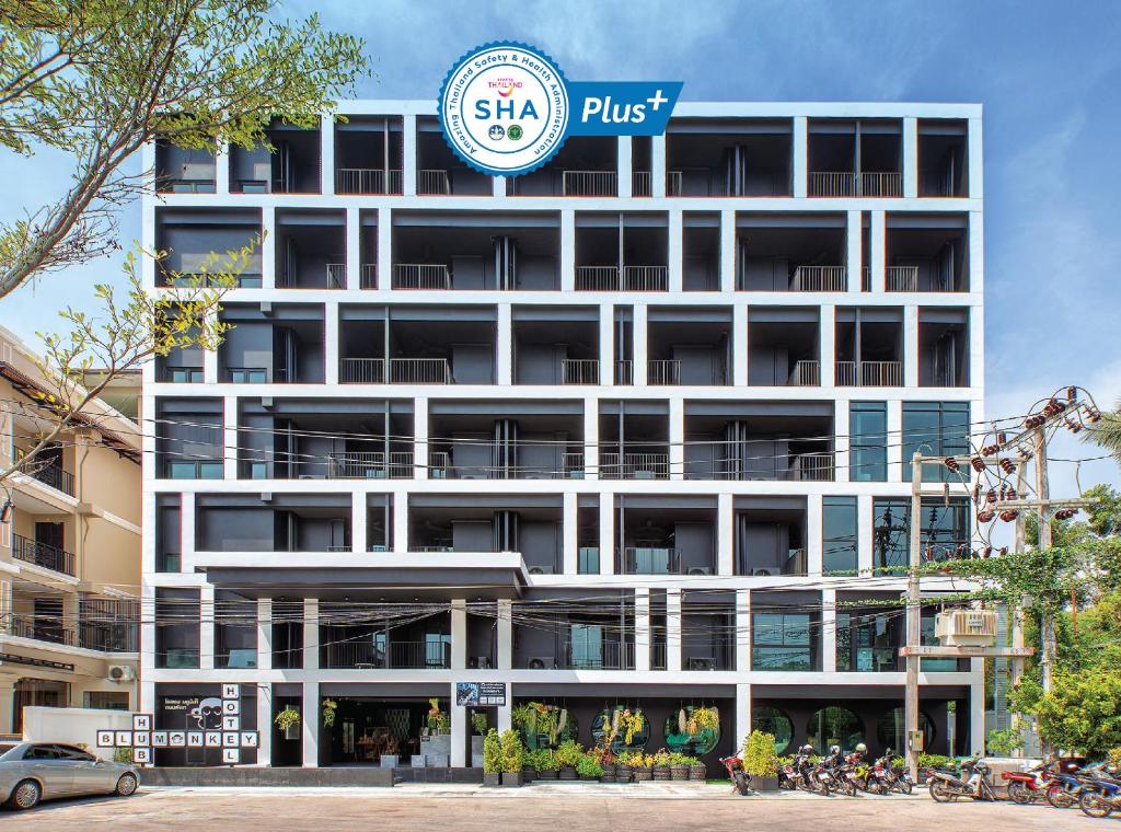 un edificio con un cartel en el costado en Blu Monkey Hub and Hotel Phuket - SHA Extra Plus en Phuket