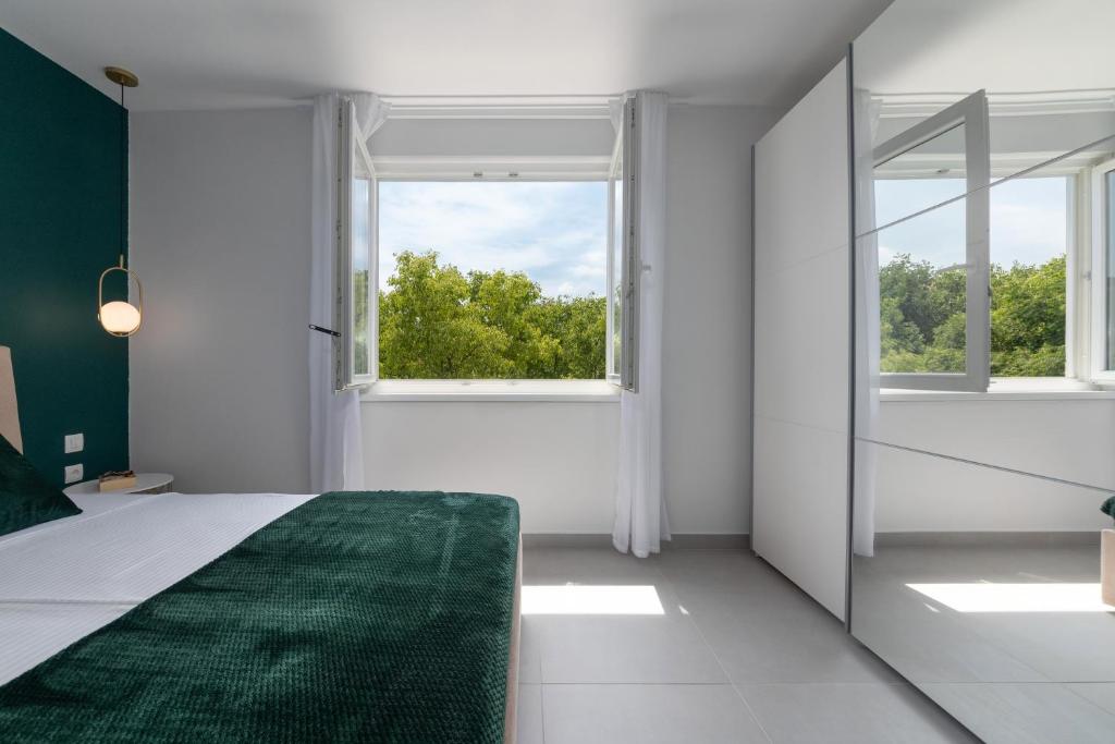 Posteľ alebo postele v izbe v ubytovaní Ampelea apartment