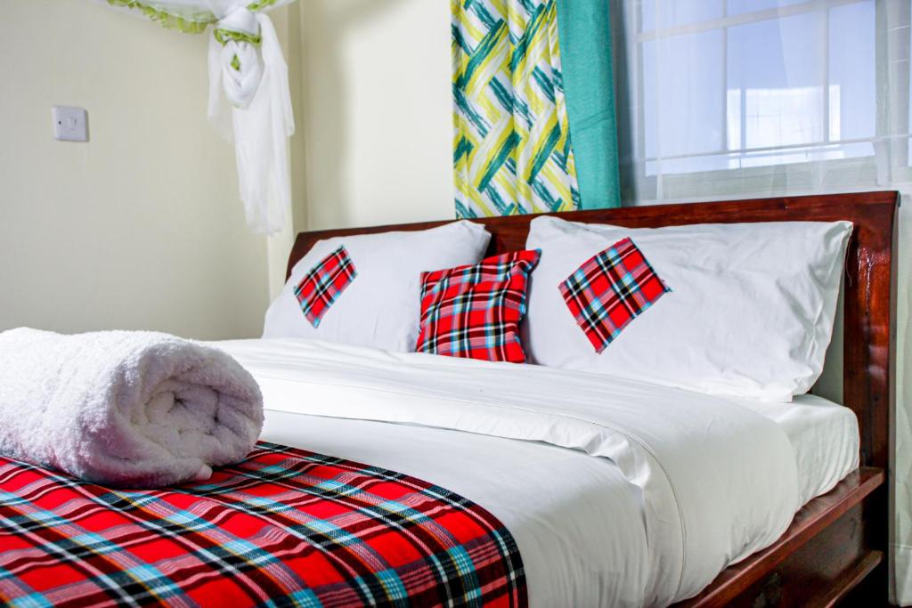 Postel nebo postele na pokoji v ubytování Kimana Omega Safari Lodge
