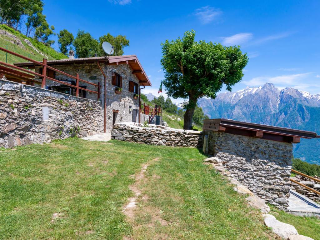 a stone house with a view of the mountains at Holiday Home La tana del lupo by Interhome in Albonico