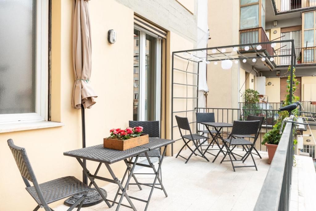 Hotel Arno River view Apartment Terraces, Free Parking, a patio with tables and chairs on a balcony at Arno River view Apartment Terraces, Free Parking in Florence
