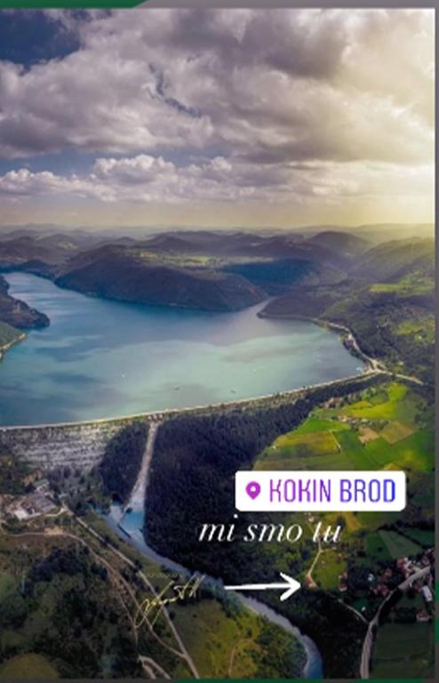 a view of a body of water with a sign at Kokin Brod Apartments in Kokin Brod
