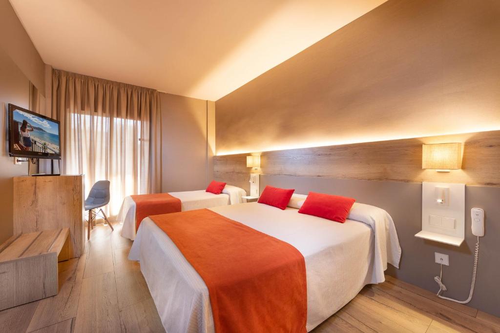 Postel nebo postele na pokoji v ubytování Hotel Montecarlo Spa & Wellness