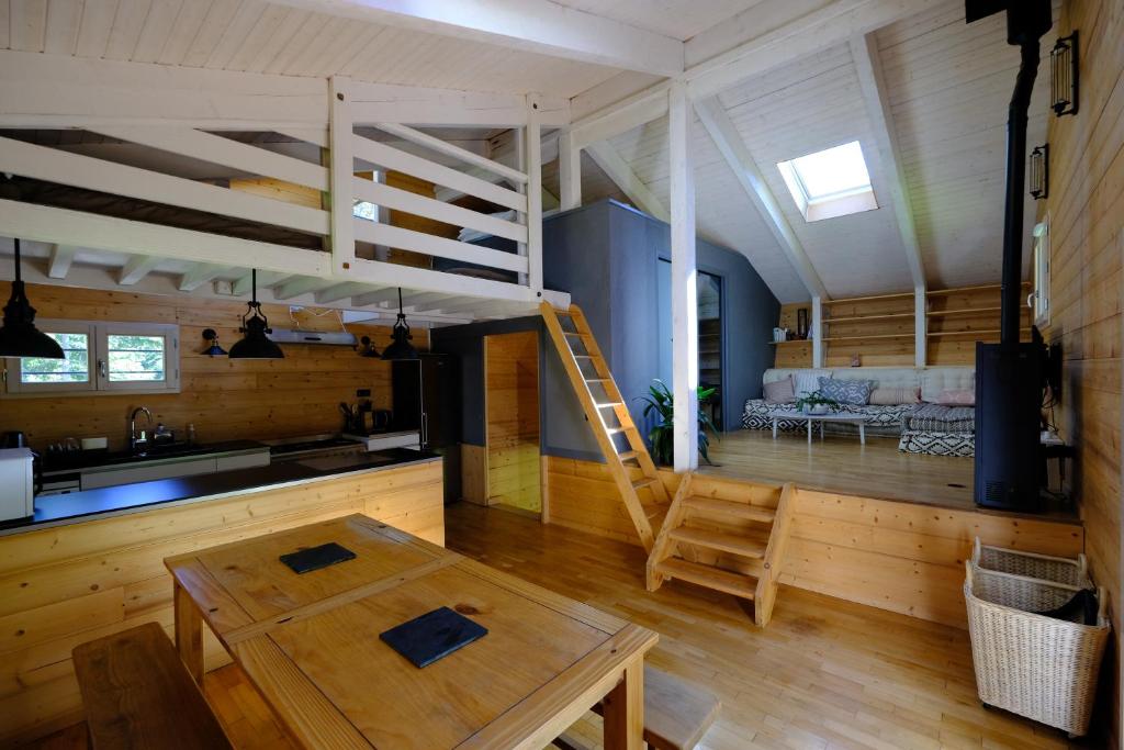 uma cozinha e sala de estar com uma cama alta em Chalet des Bruyeres em Lans-en-Vercors