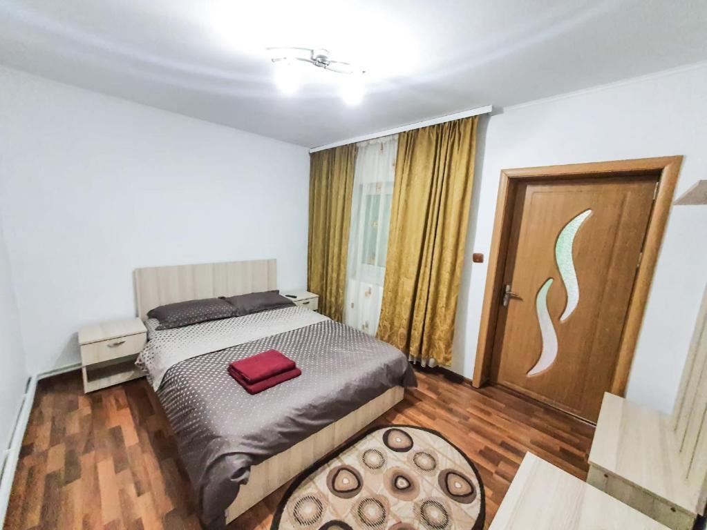 a bedroom with a bed with a red bag on it at Casa Lili in Mangalia