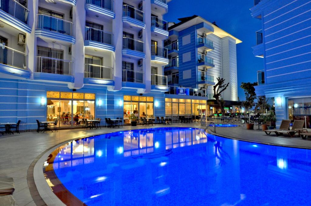 a large swimming pool in front of a building at Sultan Sipahi Resort Hotel in Alanya