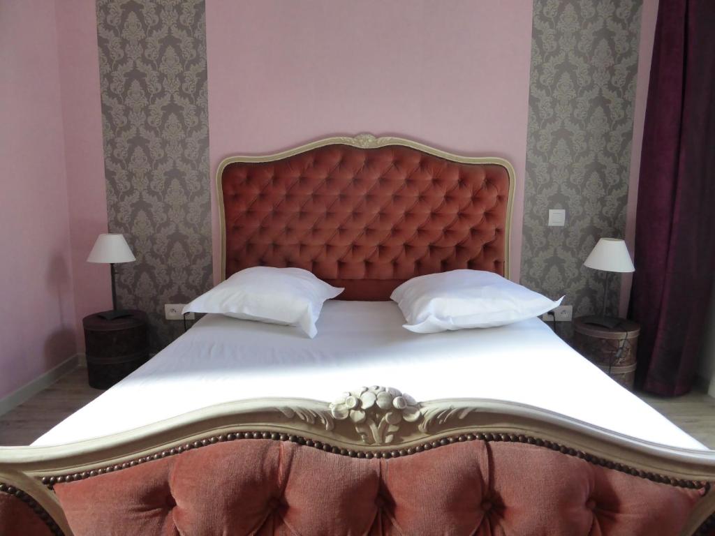 Le Bannier Hotel Restaurant في أورليان: غرفة نوم بسرير كبير مع اللوح الأمامي الأحمر