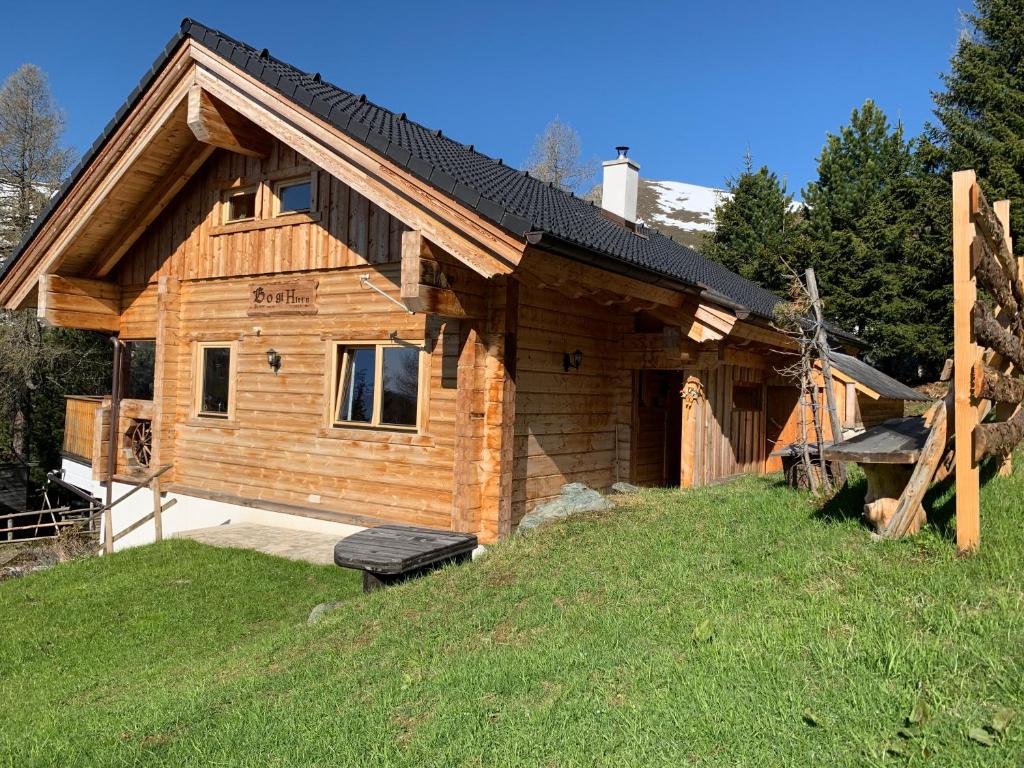 a log cabin on a hill with a grass field at Bogi Hütte -Falkert in Patergassen