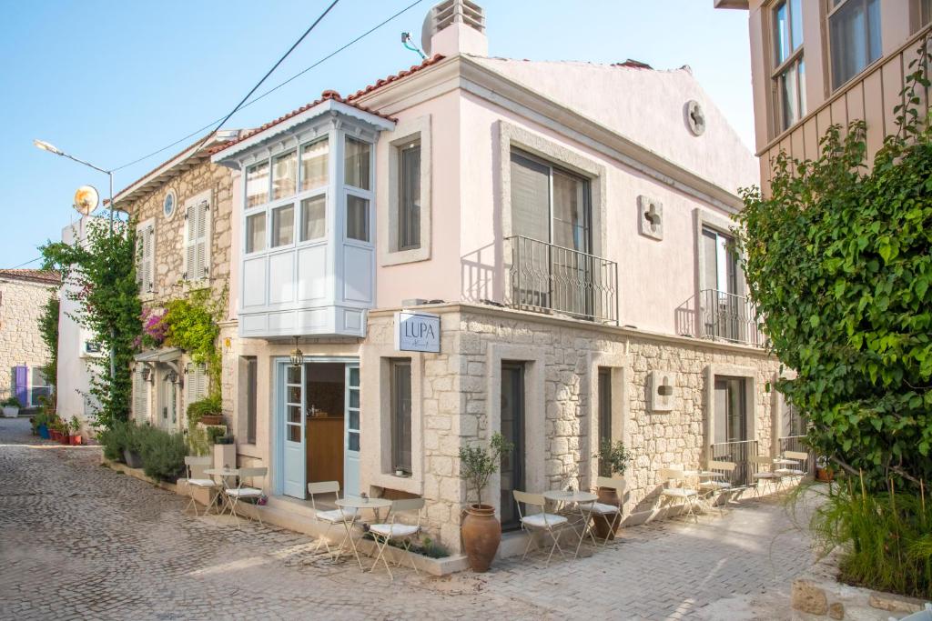 a building on a cobblestone street in front at LUPA ALAÇATI in Çeşme