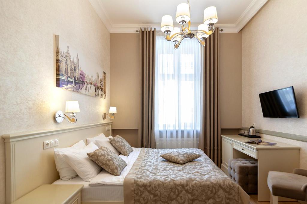 a hotel room with a bed and a window at Royal mini-apart hotel on Rynok Square in Lviv