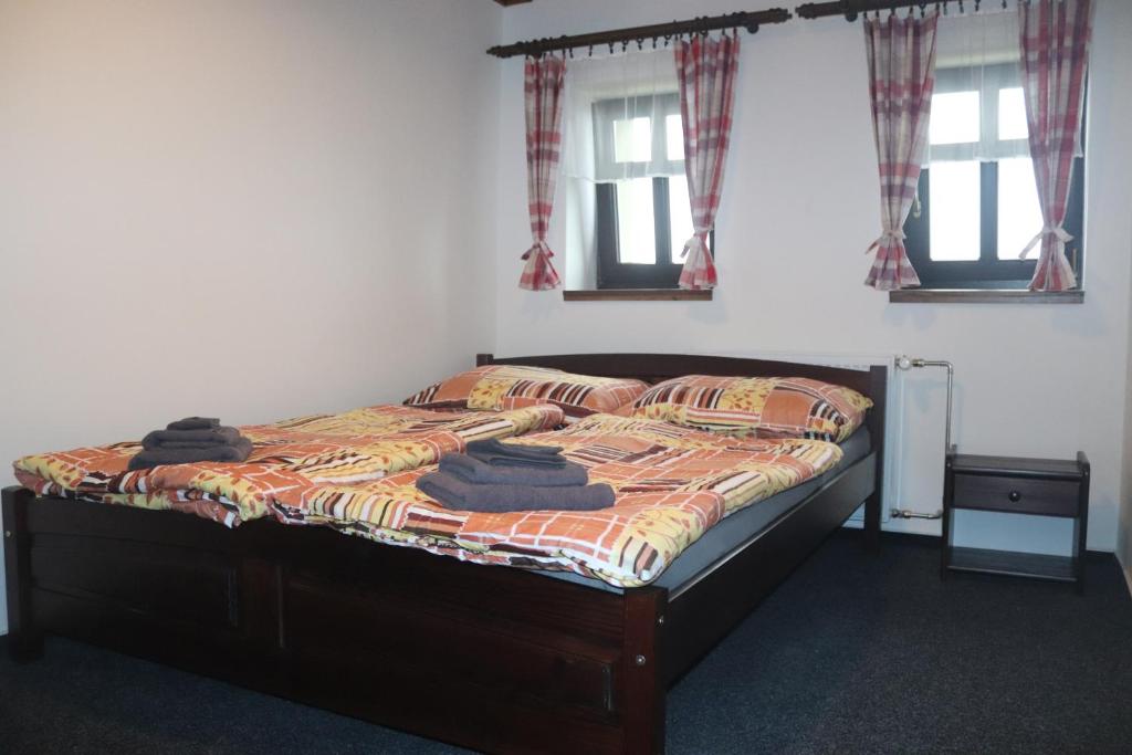 a bedroom with a bed with towels on it at apartmány Kynast in Albrechtice v Jizerských horách