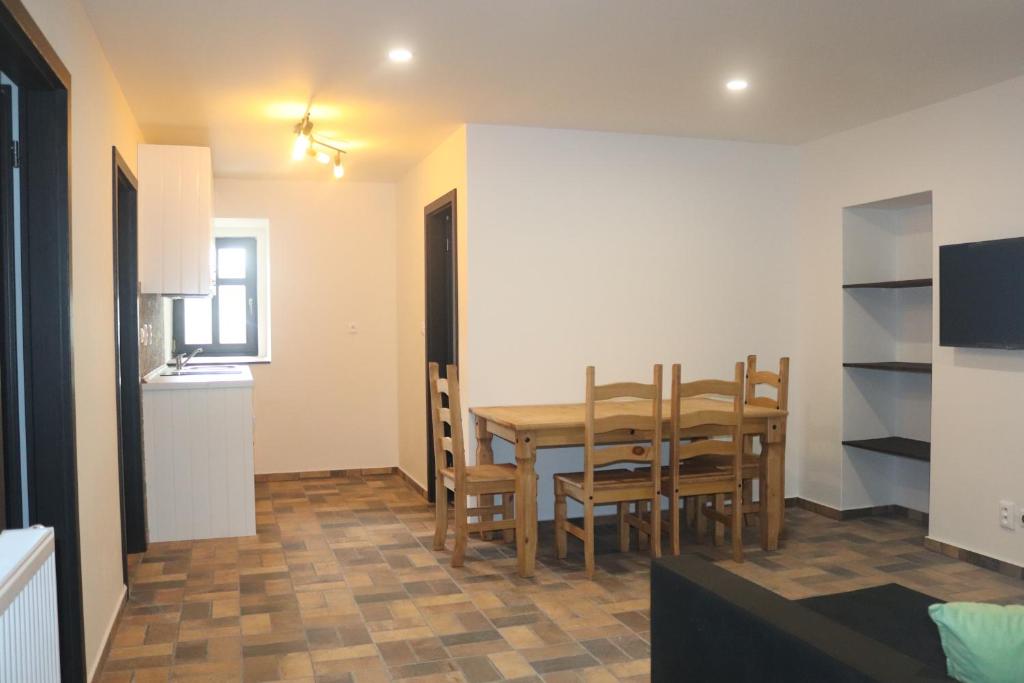 a kitchen and dining room with a table and chairs at apartmány Kynast in Albrechtice v Jizerských horách