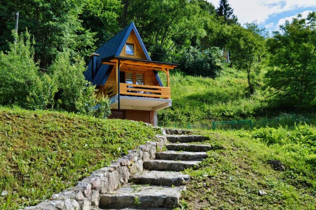 a cabin on a hill with a stone path leading to it at Malena Plivsko Jezero Jajce in Jajce