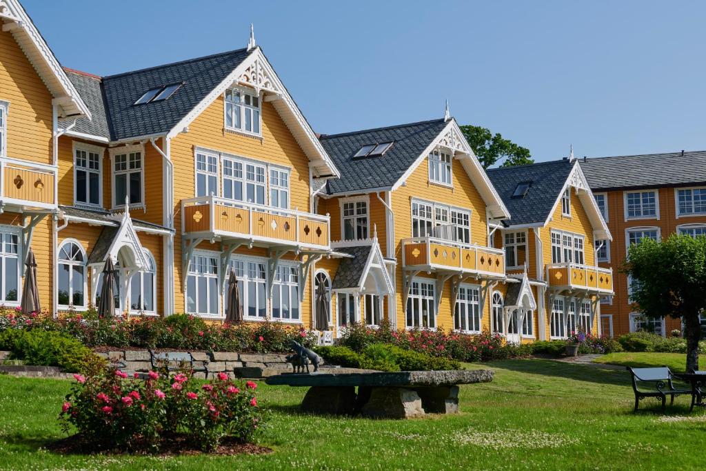 
a large building with a lot of windows in front of it at Solstrand Hotel & Bad in Osøyro
