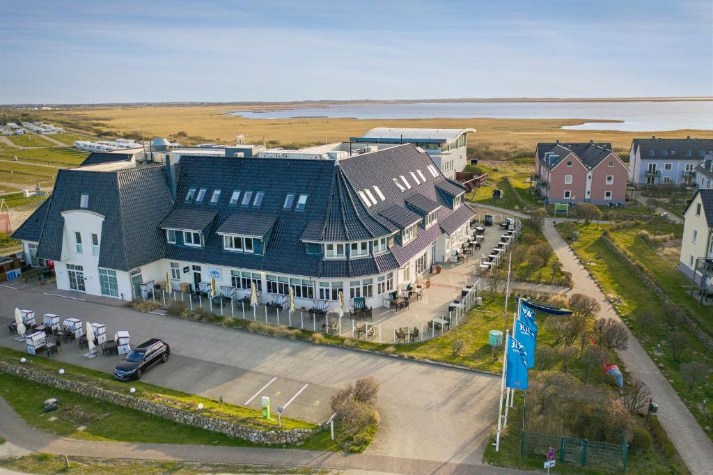 an aerial view of a large house with a blue roof at TUI BLUE Sylt in Rantum