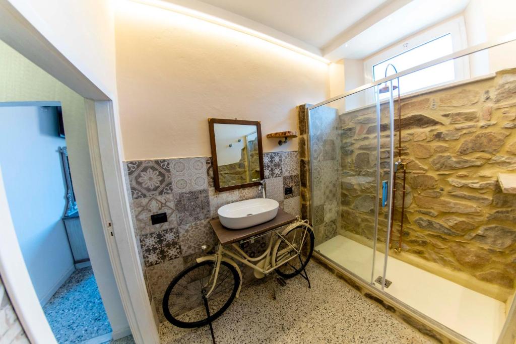 ein Badezimmer mit einem Fahrrad und einer Dusche in der Unterkunft Affittacamere Nonna Nana in Tirli