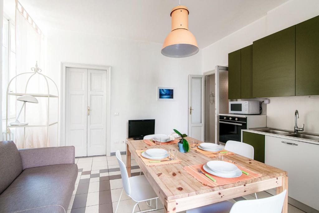 a kitchen and dining room with a wooden table at Casa Margherita-Downtown Como in Como
