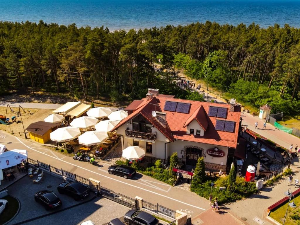 uma vista aérea de um resort com carros estacionados num parque de estacionamento em Apartamenty & Restauracja NADMORSKA em Krynica Morska