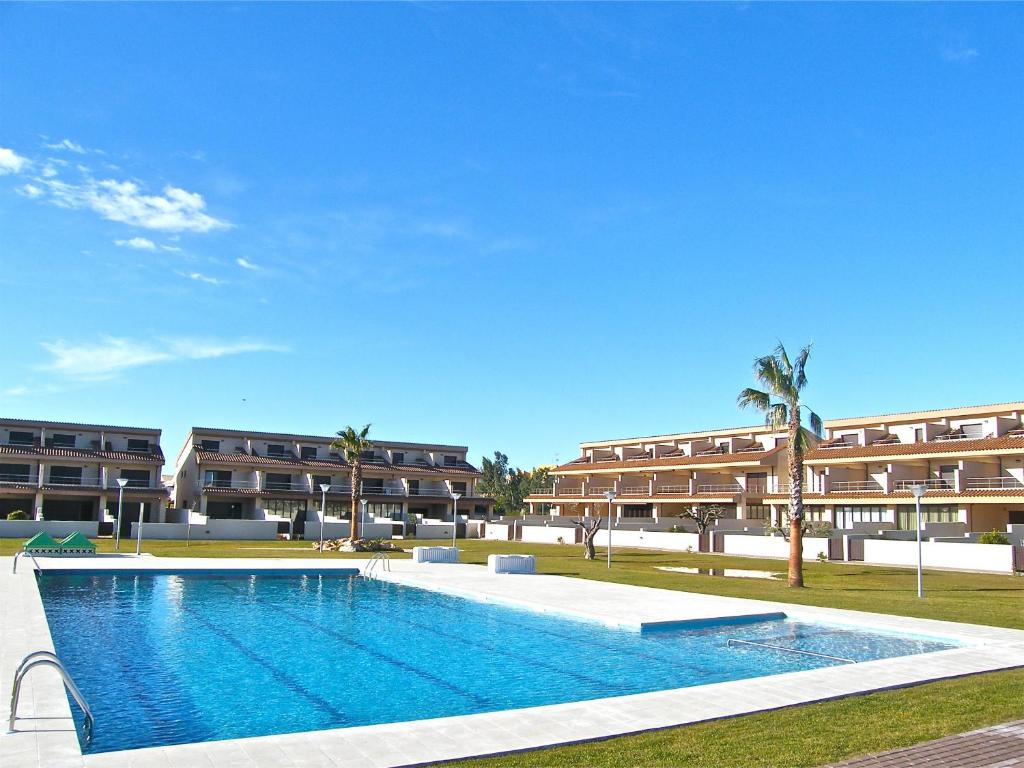 a large swimming pool in front of a building at Casa Dani in L'Ampolla