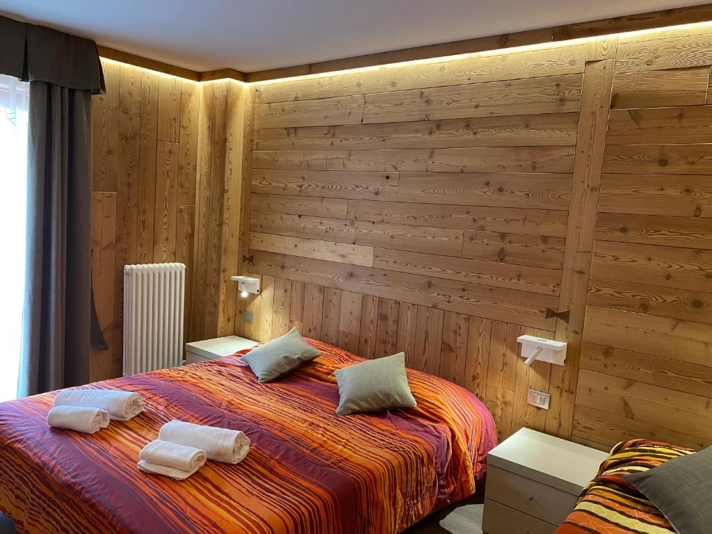 a bedroom with a bed with two towels on it at Sottosopra in Aosta