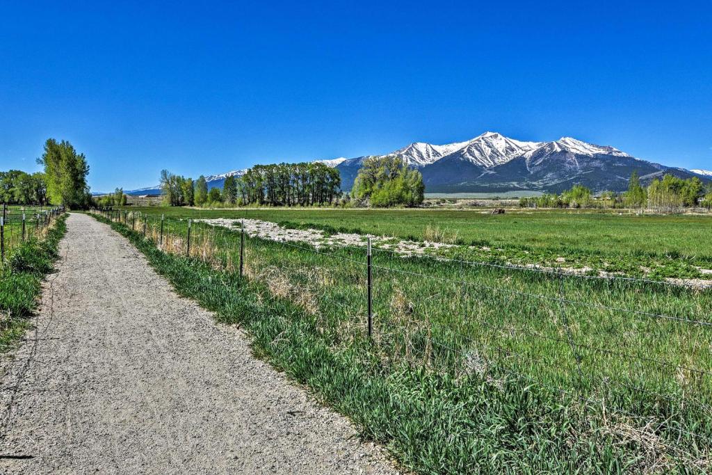 a dirt road in a field with mountains in the background at Bright Ranch-Style Retreat in Downtown Buena Vista in Buena Vista
