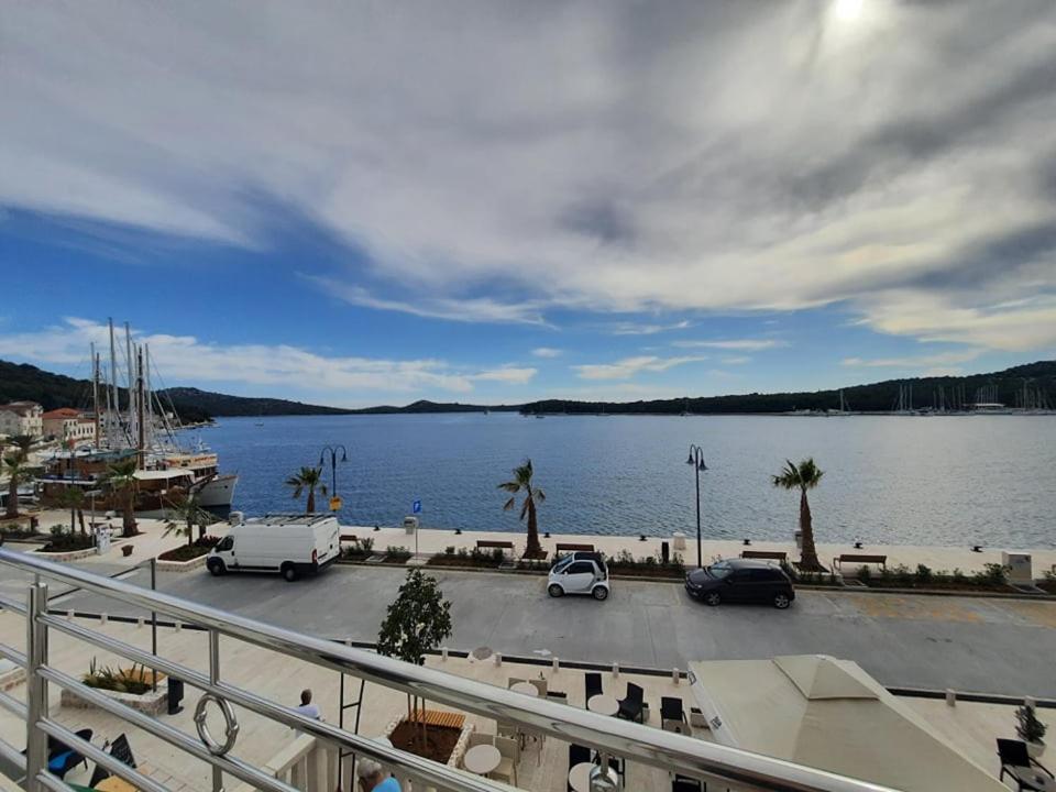 a parking lot next to a large body of water at Ojdana Živković in Rogoznica