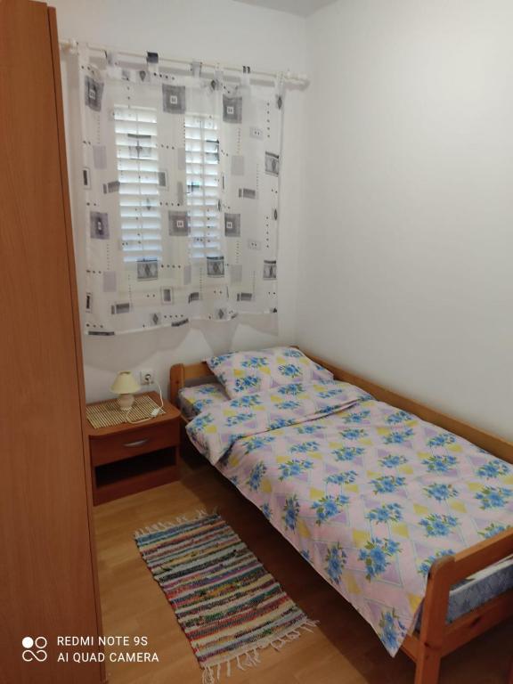 Postel nebo postele na pokoji v ubytování Apartmani Iva