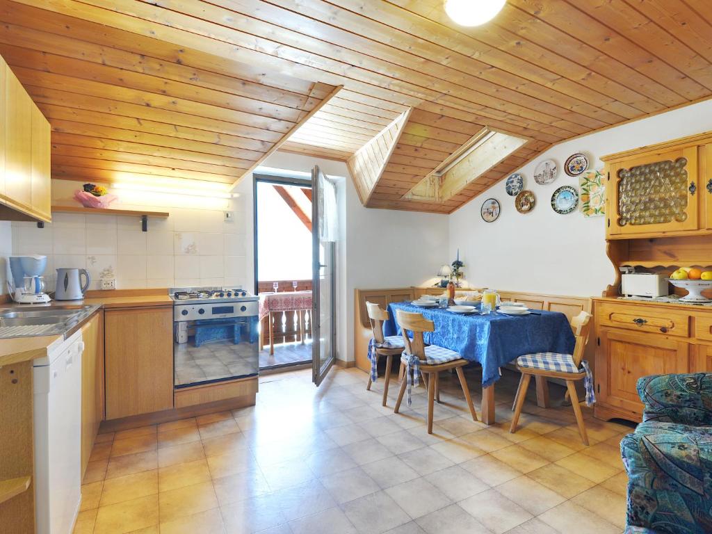 a kitchen with a table with a blue table cloth at Apartment Tieja de Gotart-4 by Interhome in Vigo di Fassa
