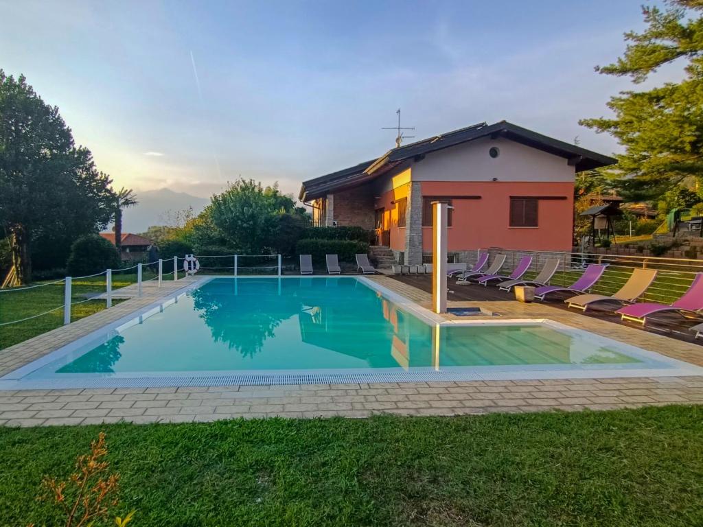a swimming pool in front of a house at Apartment Residenza Agrifoglio-16 by Interhome in Luino
