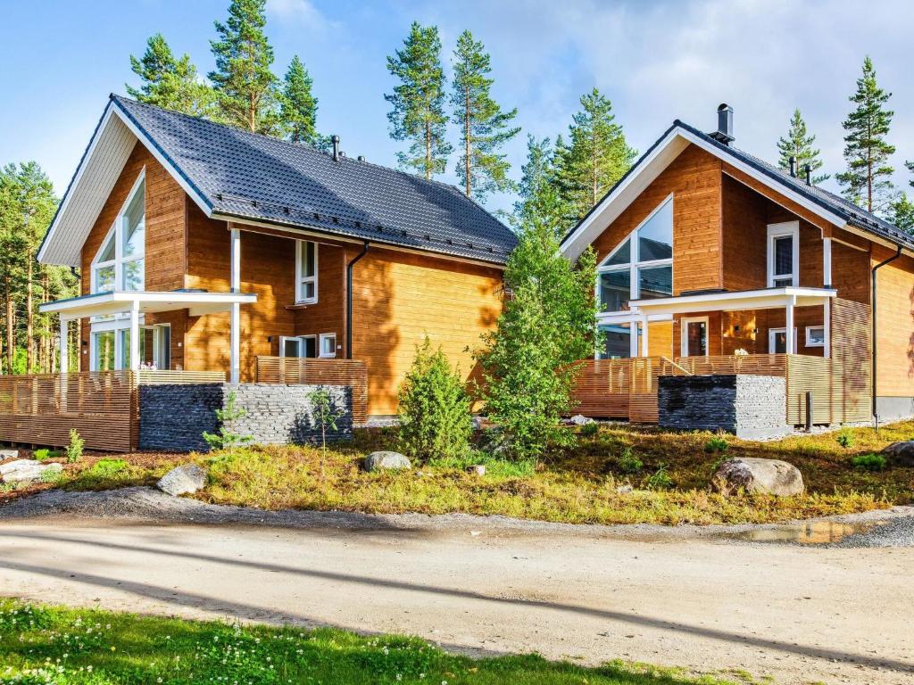 a wooden house with a black roof at Holiday Home Ritari by Interhome in Pälkäne