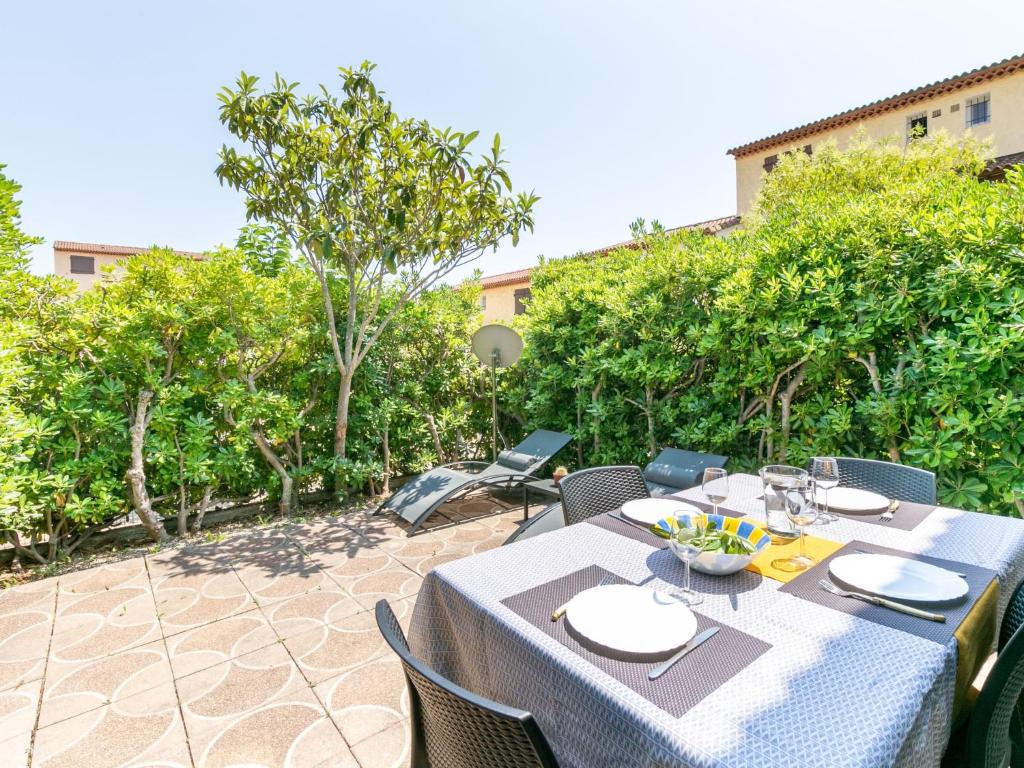 a table and chairs on a patio at Apartment Les Tulipes by Interhome in Carqueiranne