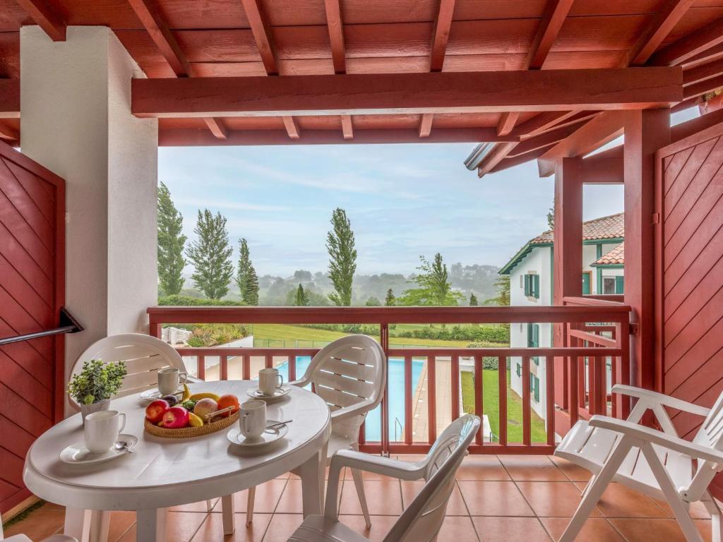 a patio with a table and chairs on a balcony at Apartment Les Terrasses d'Arcangues-4 by Interhome in Arcangues