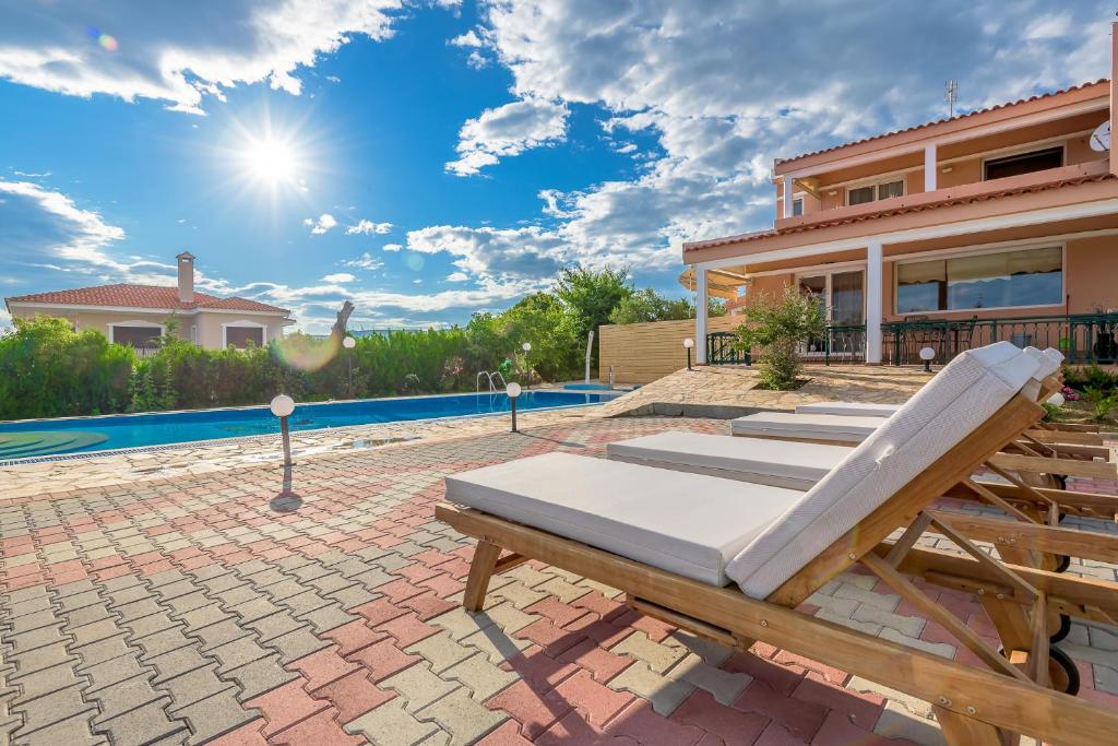 a villa with a swimming pool and a house at Villa Konstantinos in Alexandroupoli
