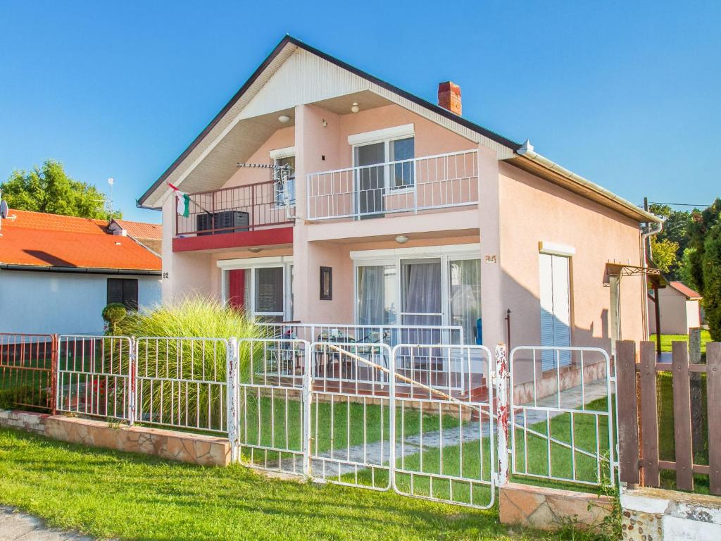 a house with a fence in front of it at Holiday Home Lampion by Interhome in Balatonmáriafürdő