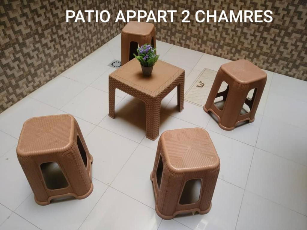 a rendering of a set of furniture and a table and stool at Appartement Beau Séjour 1 in Dakar