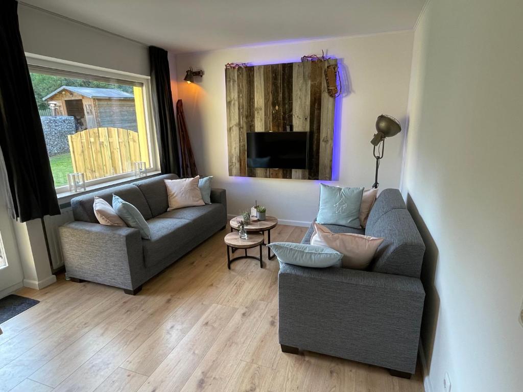 a living room with two couches and a table at Ferienwohnung UP Willingen-Schwalefeld in Willingen