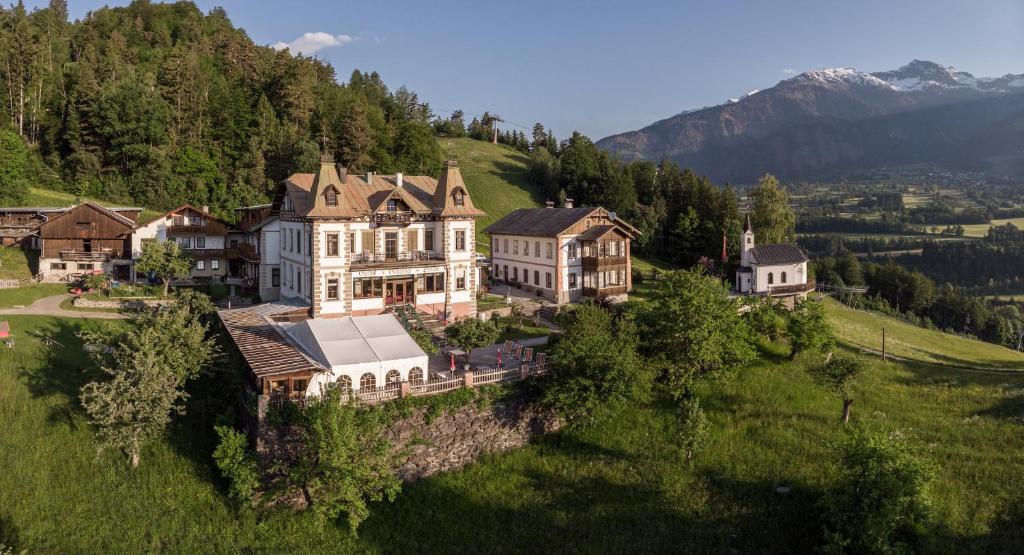 an aerial view of a large house on a hill at Hotel Gasthof Gribelehof in Lienz