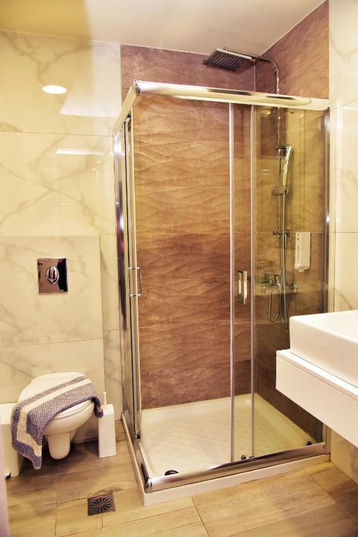 a shower with a glass door in a bathroom at Lafo Rooms in Elafonisi
